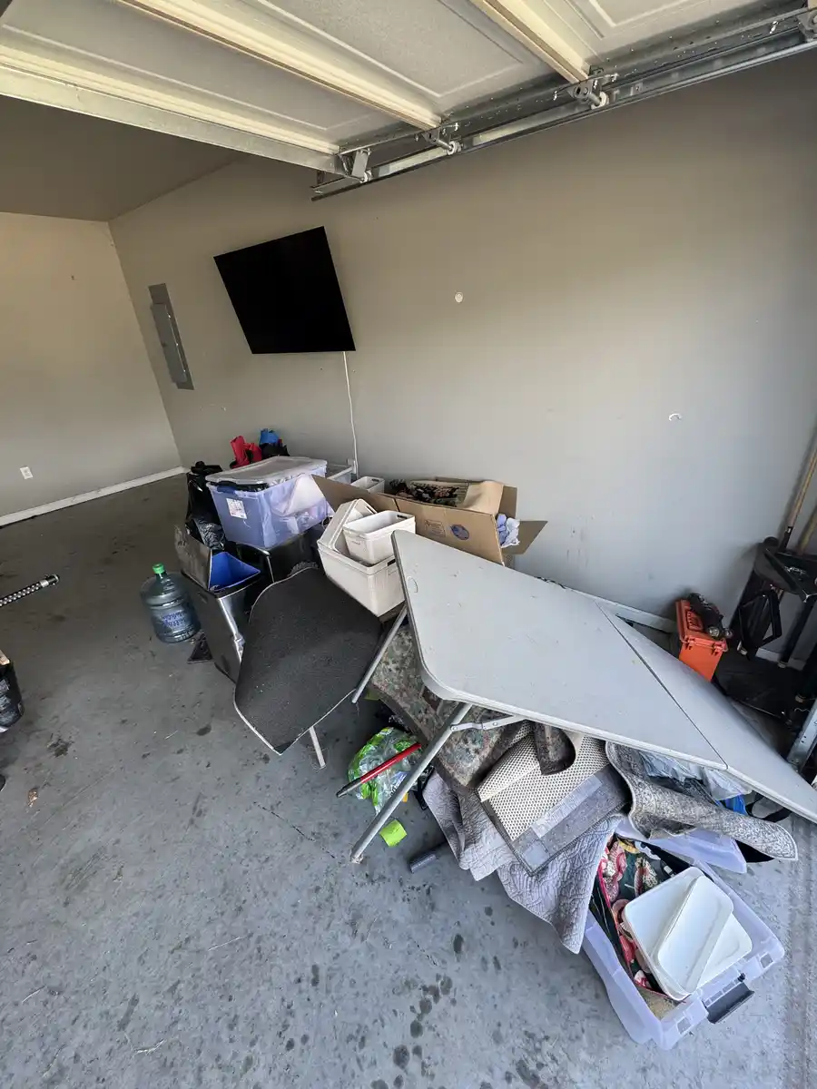Garage full of junk and clutter before removal